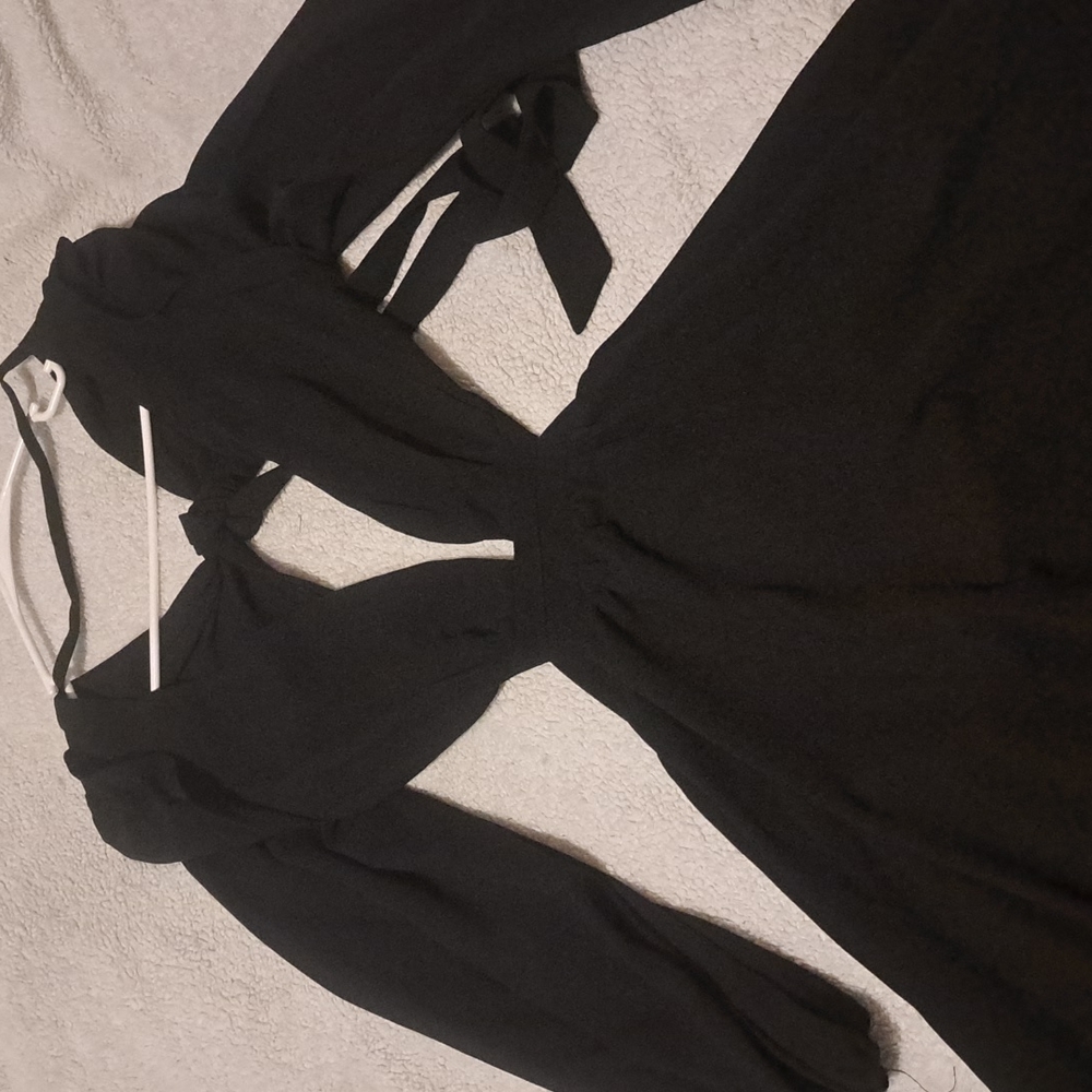 Black dress very low cut long sleeve nevr been worn. Can be dressed up or down